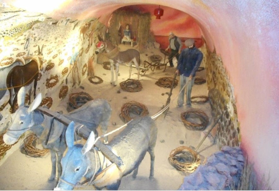 exhibit shows man ploughing with ox-cart at 'Koutsoyannopoulos Wine Museum'